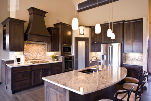 River White Arched Overhang Island Top, River White Countertop with Cherry Cabinets and Oak Flooring